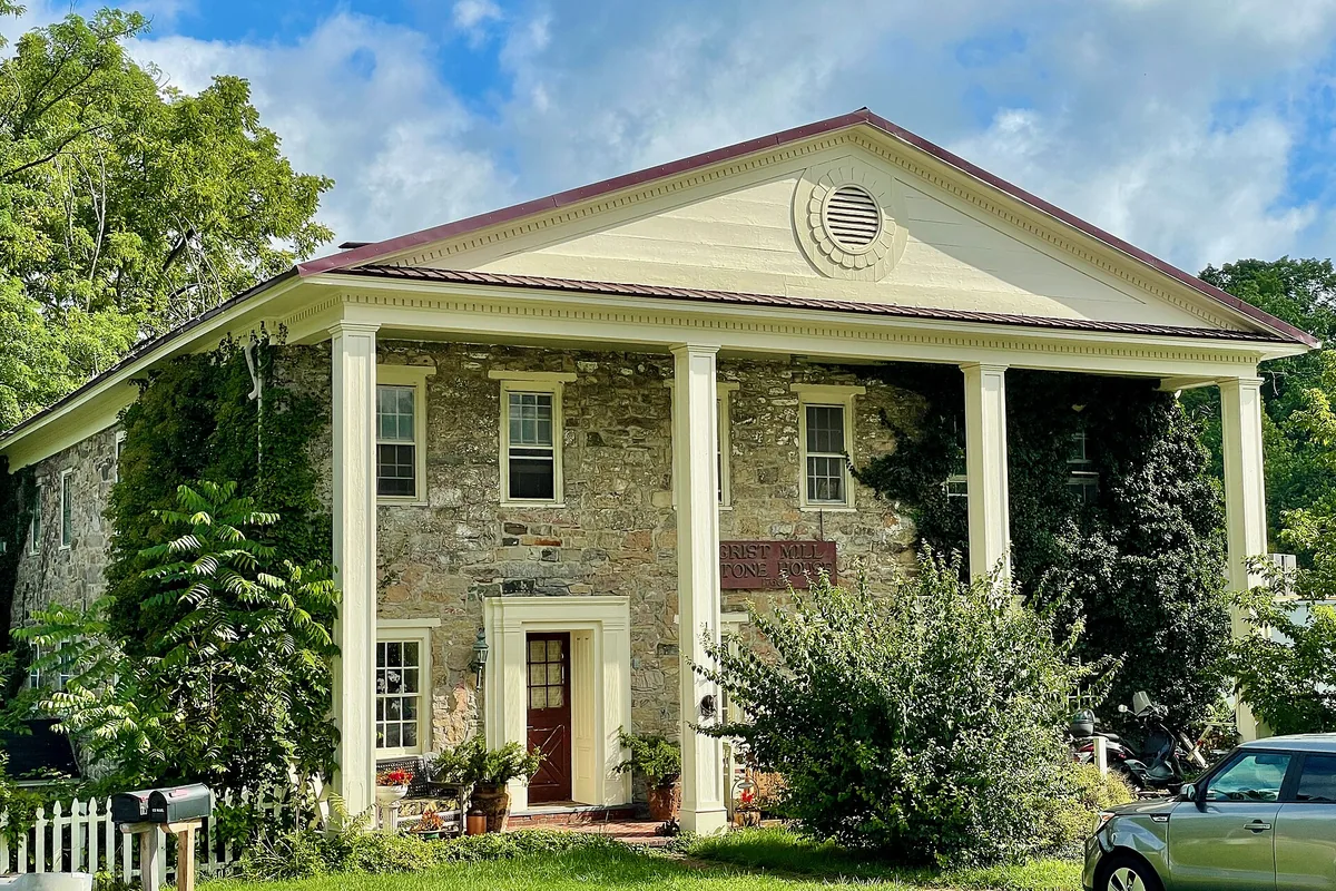 Stone grist-mill house with a columned porch on Grist Mill Lane in Andover, New Jersey